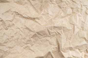 Recycled brown creased paper background from a paper packing. Crumpled brown paper texture concept