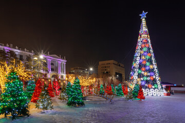 Christmas tree lights in the old part of city in Nur-Sultan at night.