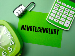 Calculator,padlock and clock with text NANOTECHNOLOGY on green background.