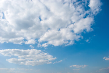 Blue sky background with tiny clouds.