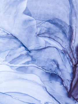 Background texture of alcohol ink in gray color. Abstract paint with drops and stains. © Galina