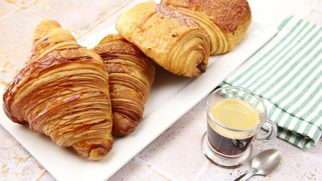 several croissants and pains au chocolat on a table