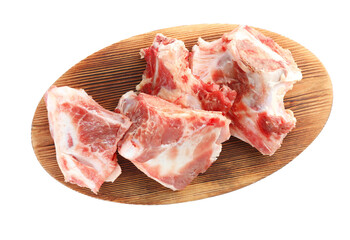 Wooden board with raw chopped meaty bones on white background, top view