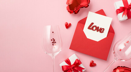 Top view photo of st valentine's day decorations open red envelope with card and inscription love small hearts gift boxes wineglasses confetti heart shaped balloons on isolated pastel pink background