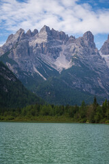 Fototapeta na wymiar A majestic view of Durrensee lake in Italy surrounded by beautiful forested mountains in the Dolomites at summer in south Tirol