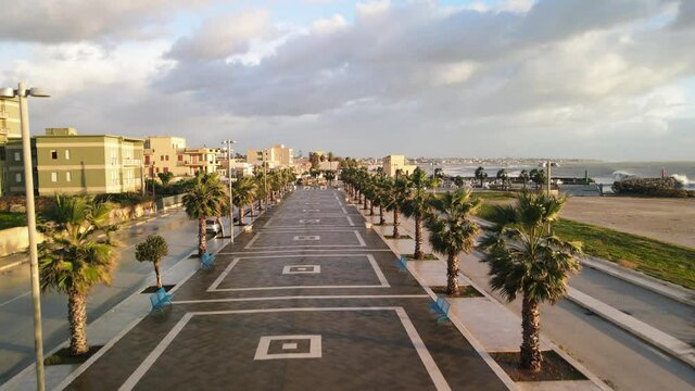 Aerial view of Mazara del Vallo city promenade along the ocean, beautiful coast of Sicily at sunset from drone