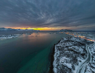 Small snowy Islands at the Norwegian Coast during Polar Night with the "Sunset" in the background - Drone Perspective Landscape Photography