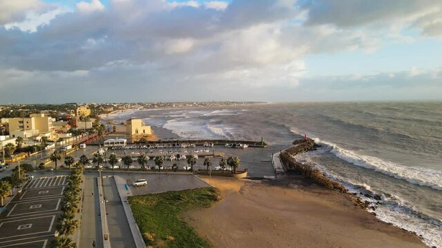 Aerial view of Mazara del Vallo city promenade along the ocean, beautiful coast of Sicily at sunset from drone