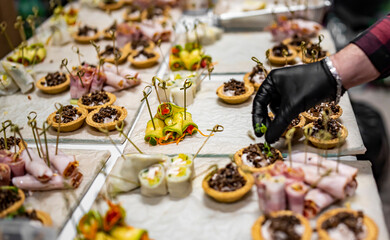 Chef hand is in process of Preparing catering food