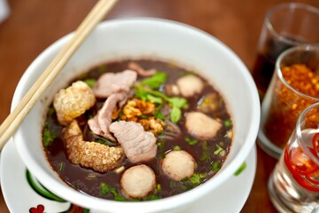 Spicy pork noodle soup and meat balls.
