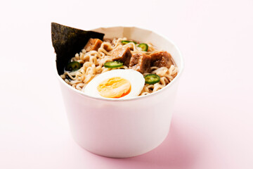 Bowl with soy sauce, Asian noodles, egg ramen and tofu. Traditional Asian dish.
