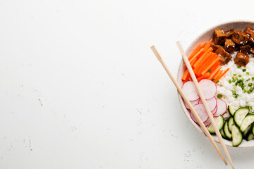 Poke bowl, lunch bowl with fresh vegetables and rice. Asian chopsticks