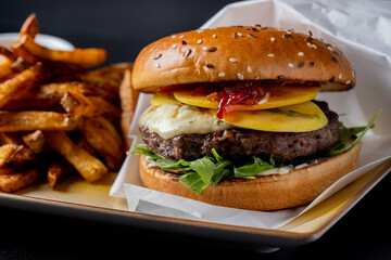 details of tasty beef hamburger with gorgonzola cheese and fries