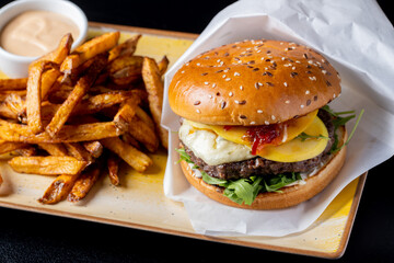 details of tasty beef hamburger with gorgonzola cheese and fries