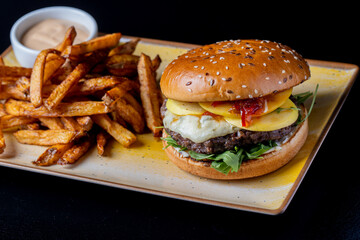 details of tasty beef hamburger with gorgonzola cheese and fries