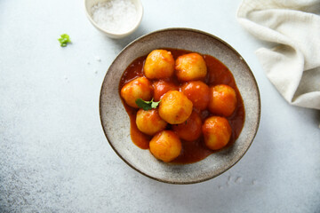 Traditional homemade dumplings with tomato sauce