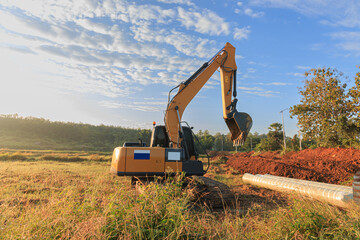Crawler Excavator is digging in the construction site pipeline work with cloud and sky ...