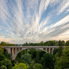 Amazing view from the unique Adolf bridge in Luxembourg surrounded by green trees under blue sky...