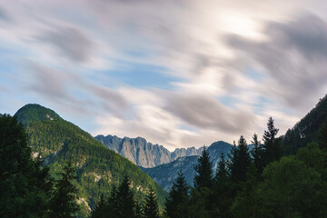 Long exposure of moving clouds in mountain landscape with forest in Julian Alps, Triglav National Park, Slovenia