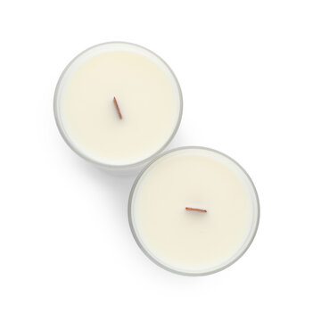 Aromatic soy candles with wooden wicks on white background, top view