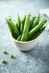 Fresh green pea in a white bowl