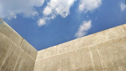 blue sky and concrete wall - Powered by Adobe