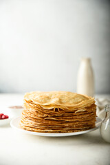 Traditional homemade crepes on a white plate