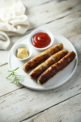 Homemade roasted sausages with ketchup and mustard