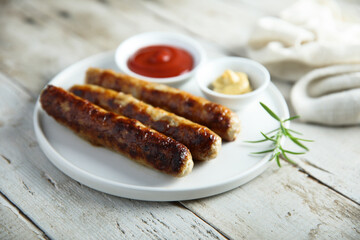 Homemade roasted sausages with ketchup and mustard