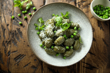 Homemade spinach gnocchi with green pea