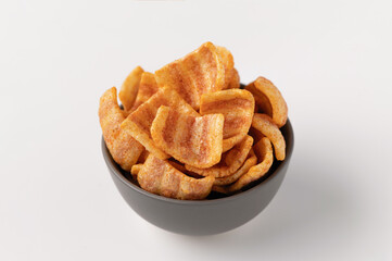 bacon snacks in a ceramic bowl, appetizer, on a white plate close-up