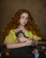 Portrait of a red-haired girl hugging a vintage clock to her chest