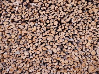 Pile of neatly stacked firewood, background.