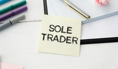 SOLE TRADER, text on white notepad on craft background