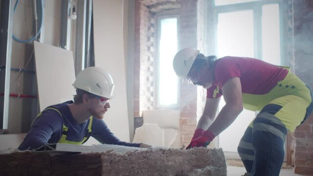 Builders cut fiberglass at construction site. Realtime