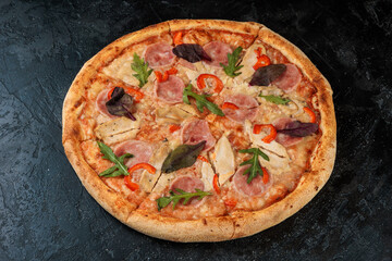 Tasty pizza on black concrete background. Top view of hot pizza. 