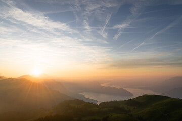 Beautiful spring sunset on mountaintop with view of a lake