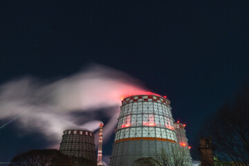 thermal power plant cooling towers soar in winter at night