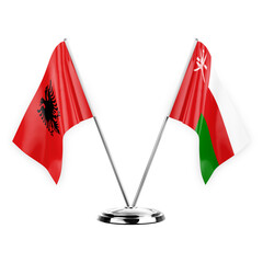 Two table flags isolated on white background 3d illustration, albenia and oman