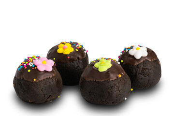 Side view of homemade chocolate balls topping with colorful rainbow sprinkles and sugar flower on white background with clipping path.