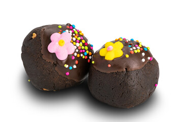 Choc balls or chocolate balls topping with multicolored rainbow sprinkles and colored sugar flower isolated on white background with clipping path.