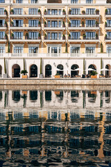 Fototapeta na wymiar Reflection of the Regent Hotel in the water. Porto, Montenegro