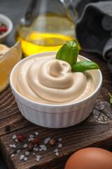 Mayonnaise with fresh basil close-up. Side view, vertical.