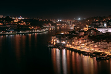 Fototapeta na wymiar Night view over Porto, taken from the iconic bridge spanning over the beautiful city located in Portugal.