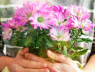 Fototapeta na wymiar International Women's Day. Womans hands hold bouquet of flowers. postcard, banner or flyer of March 8