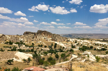 Fototapeta na wymiar Cappadocia is not only hot air balloons, but also beautiful landscapes of houses in rocks and greenery. Cappadocia, magic music frozen in stone.