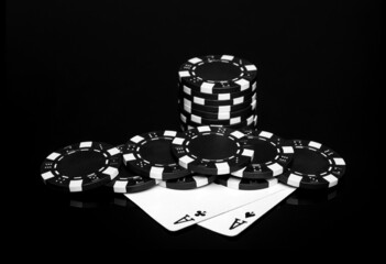 Poker cards with one pairs combination in casino. Chips and cards on the black table.