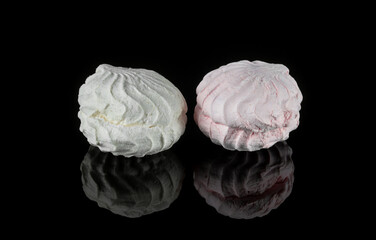 Airy marshmallow dessert marshmallows. Two sweet pieces of marshmallow on a black background. Dessert meringue.