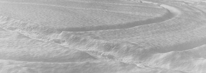deep snow with bending tire tracks.  Black and white.
