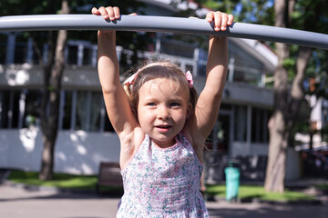 Obraz premium Child on the playground on a summer day. Real people